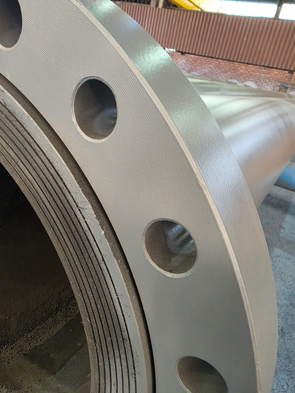 Close-up of an HDPE-lined steel pipe flange face fabricated by Wetpipe